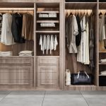 Modern wooden wardrobe with neatly organised clothes, drawers, and shelves for a stylish bedroom storage solution